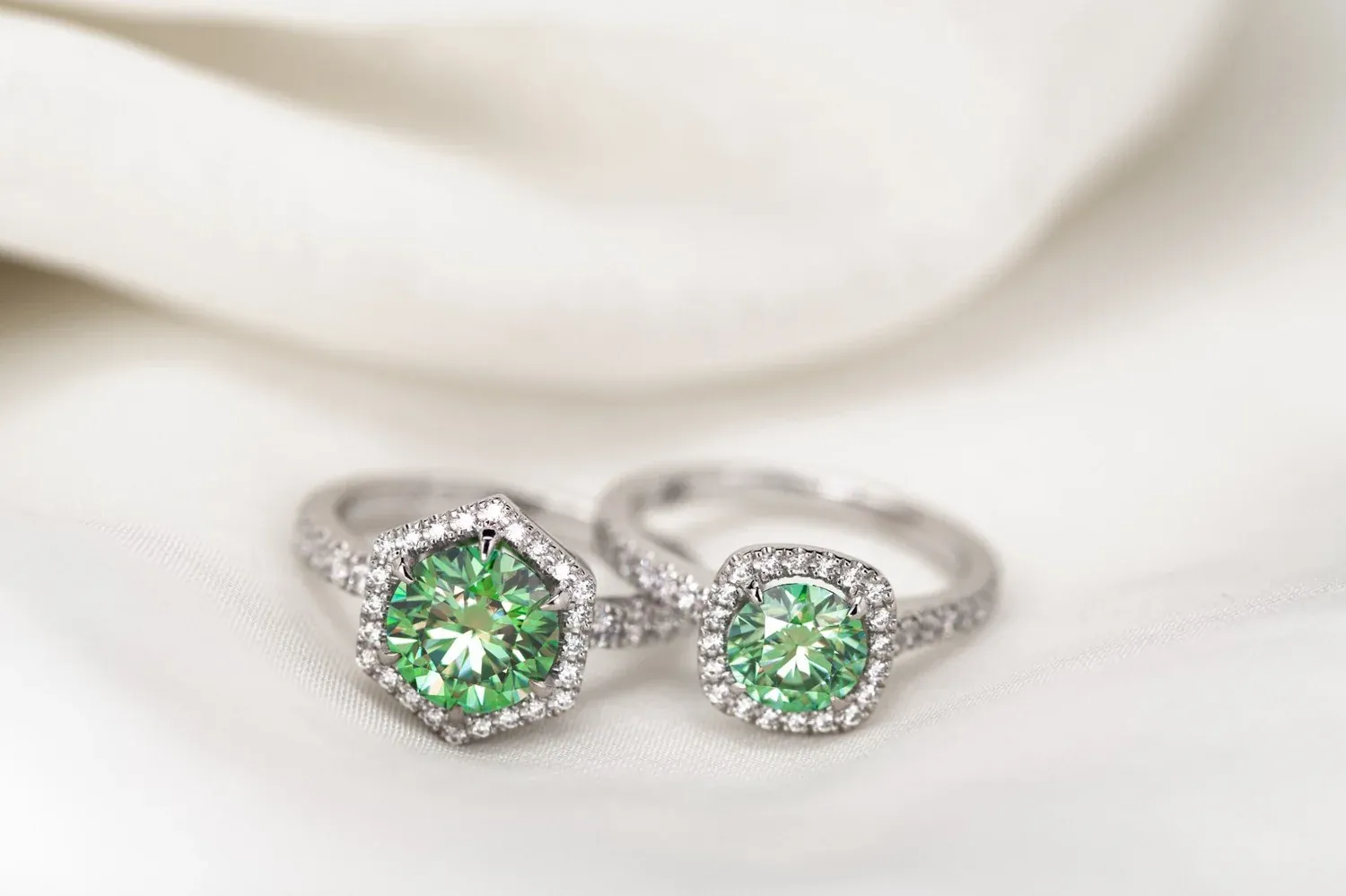 A pair of gemstone halo rings made by Vulcan.